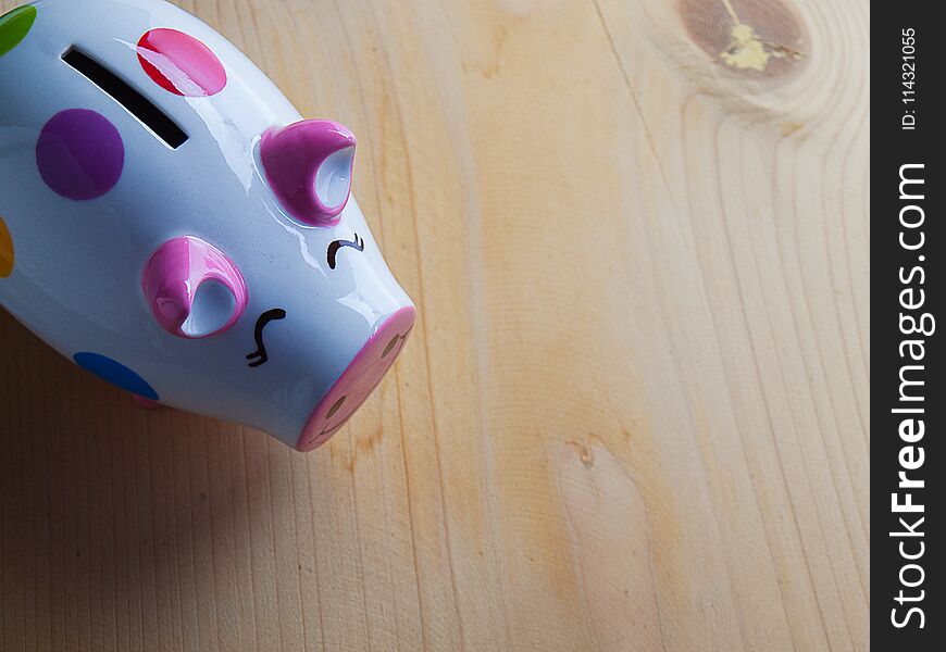 Close Up piggy bank , Put on wooden floor.with free space for text