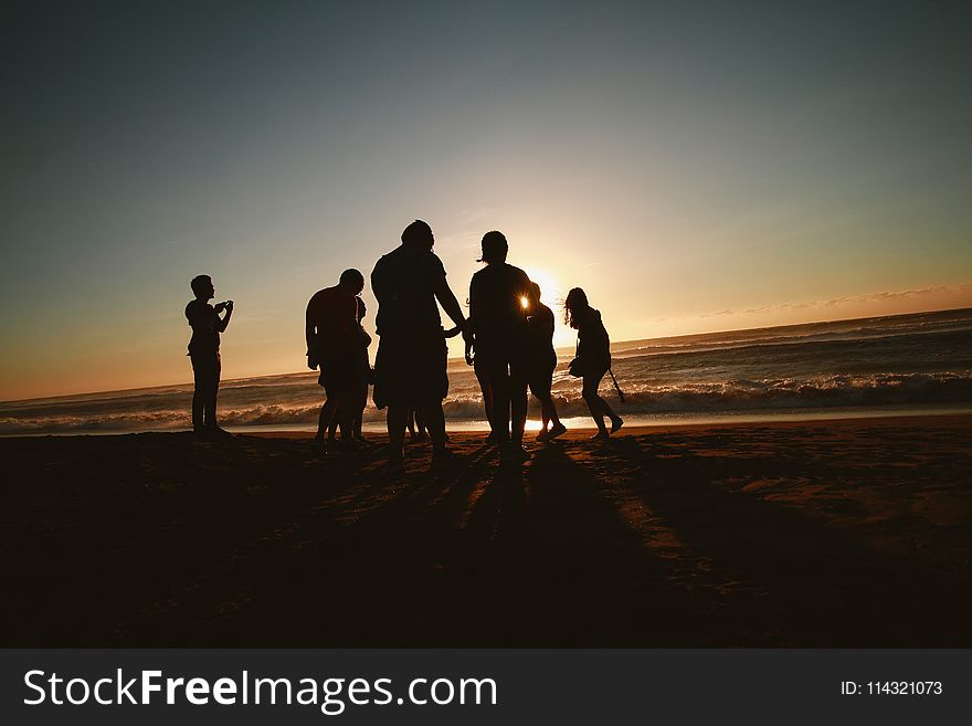 Silhouette Photo of People at the Seashore