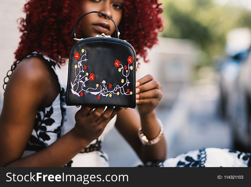 Woman Holding Black Leather Handbag