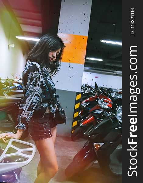 Photography Of A Woman Near Motorcycles