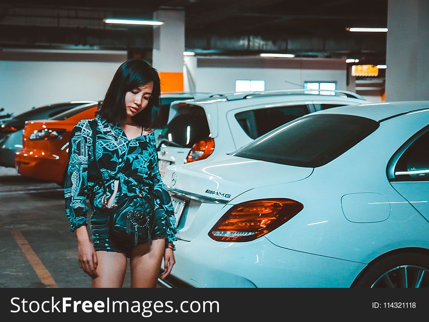 Woman Wearing Blue Printed Romper Standing Beside Car