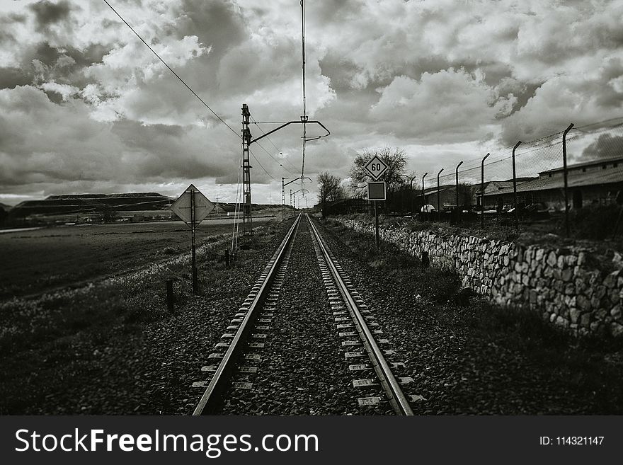 Grayscale Photograph of Train Rail