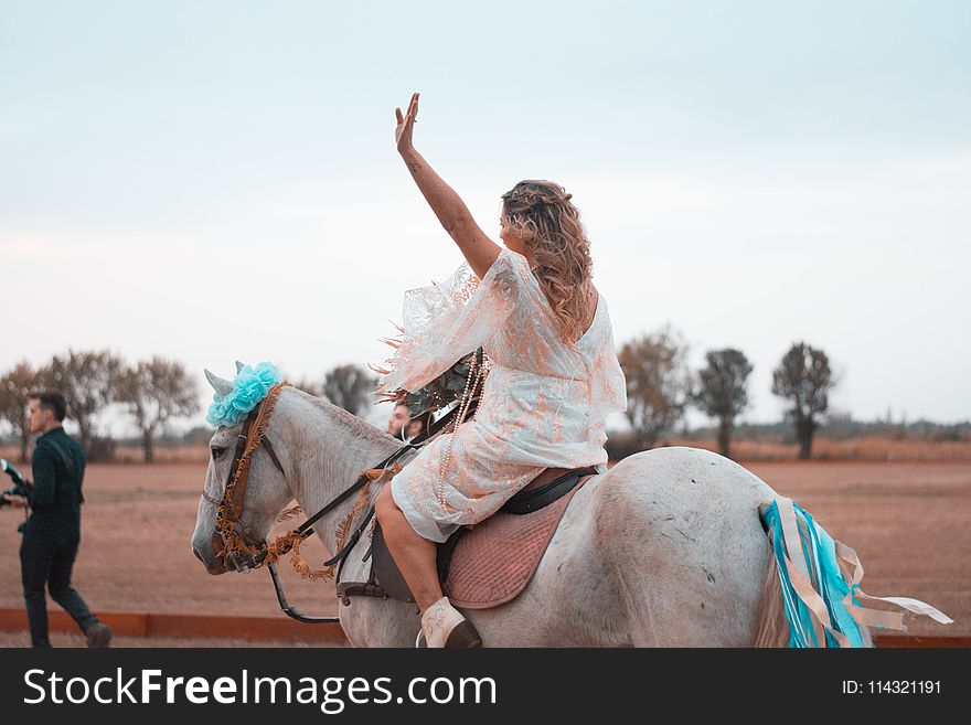 Woman Riding on White Horse