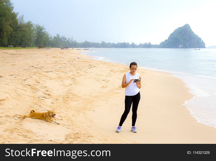 Woman relax morning with dog on beach