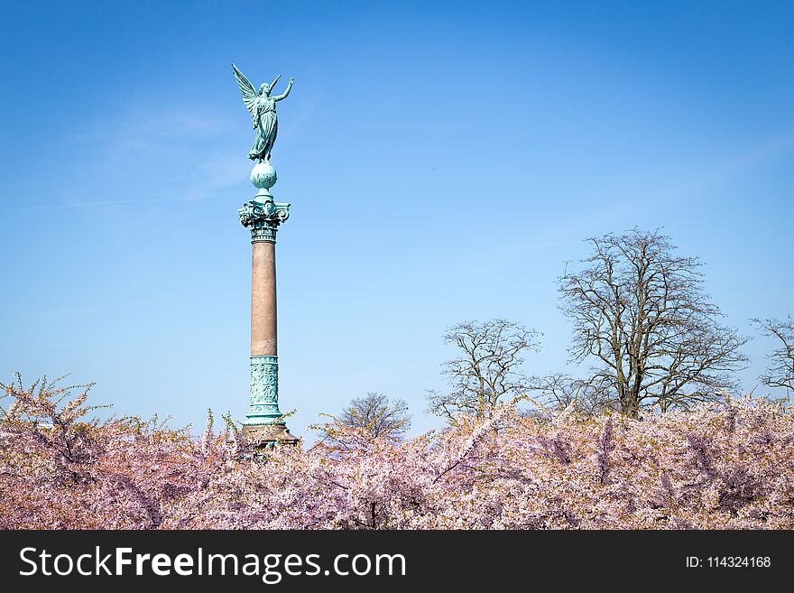 Copenhagen, Denmark - May 02, 2016: Ivar Huitfeldt monument at Langelinie Park and cherry blossom trees. Monument design by Vilhelm Dahlerup. Copenhagen, Denmark - May 02, 2016: Ivar Huitfeldt monument at Langelinie Park and cherry blossom trees. Monument design by Vilhelm Dahlerup.