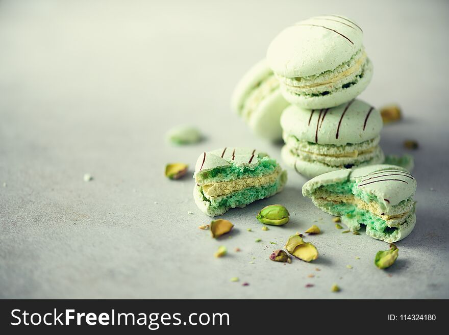 Green Mint French Macaroons With Pistachios. Pastel Colors Macarons, Copy Space. Holidays And Celebrations Concept