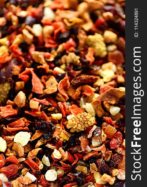 Mix tea karkade with dried fruits and flowers. Fruit tea background and texture. Top view. Food background. Organic healthy herbal leaves, detox tea