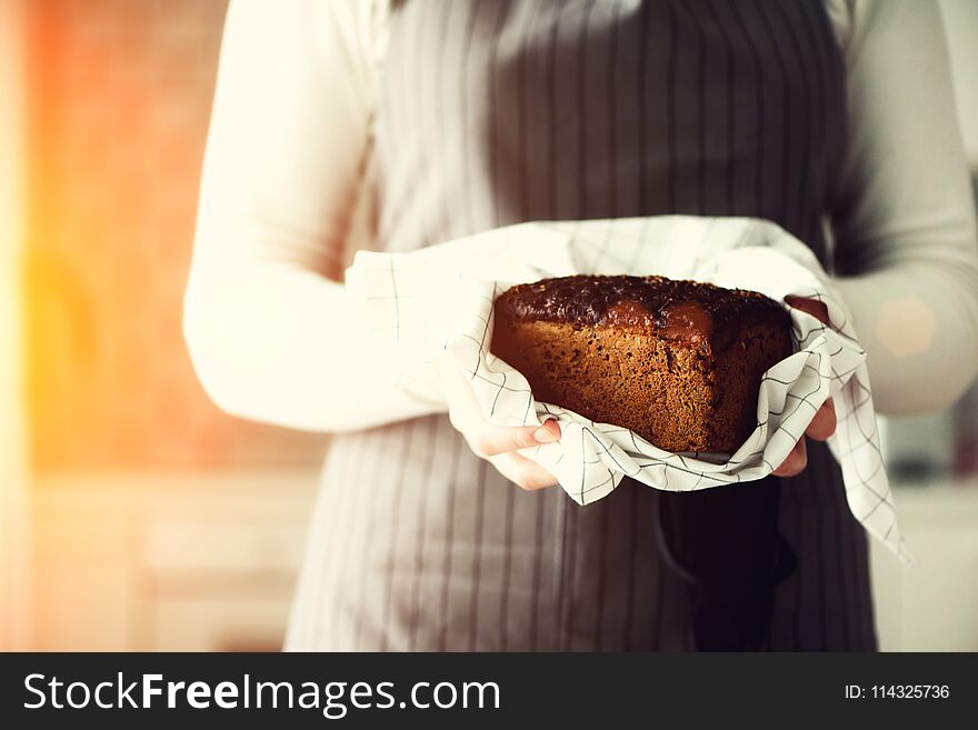 Woman hands holding freshly baked bread. Handmade brown loaf of bread, bakery concept, homemade food, healthy eating
