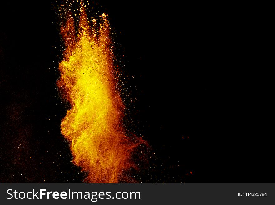 Red orange color powder explosion cloud isolated on black background. Red orange color powder explosion cloud isolated on black background.