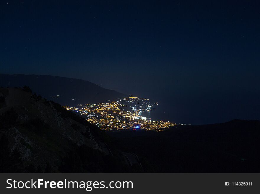 Stunning views of the night city from Mount Ai-Petri peninsula Crimea. Mountain landscape.