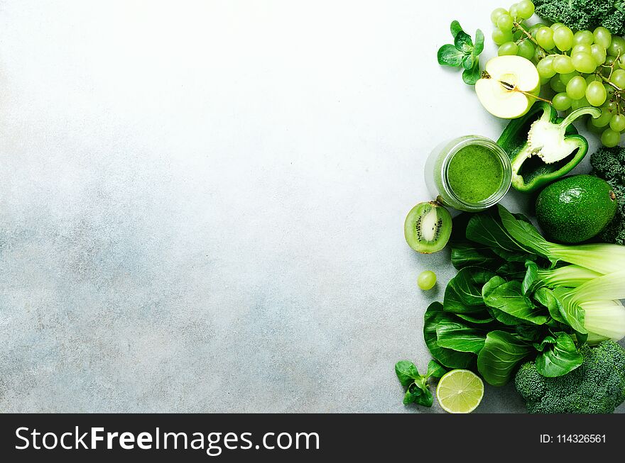 Green Smoothie In Glass Jar With Fresh Organic Green Vegetables And Fruits On Grey Background. Spring Diet, Healthy Raw