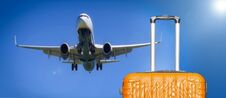 Suitcases And The Boarding Plane In The Blue Sky Royalty Free Stock Photography