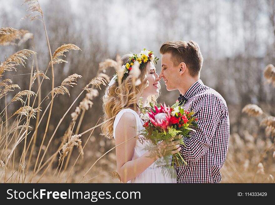 A Young Couple Tenderly Looking At Each Other Amid The Reeds 582