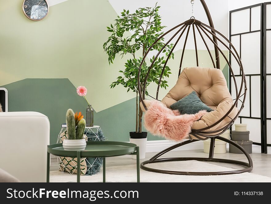 Stylish living room interior with pendant chair