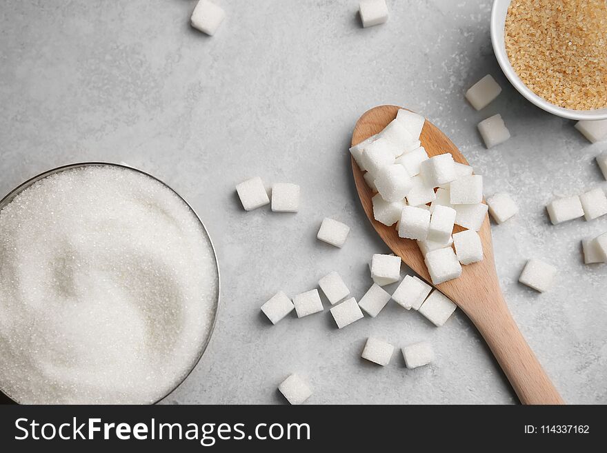 Composition with various kinds of sugar on gray background