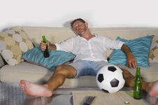 Young Wasted Soccer Supporter Man Lying On Home Sofa Couch Sleep Royalty Free Stock Image