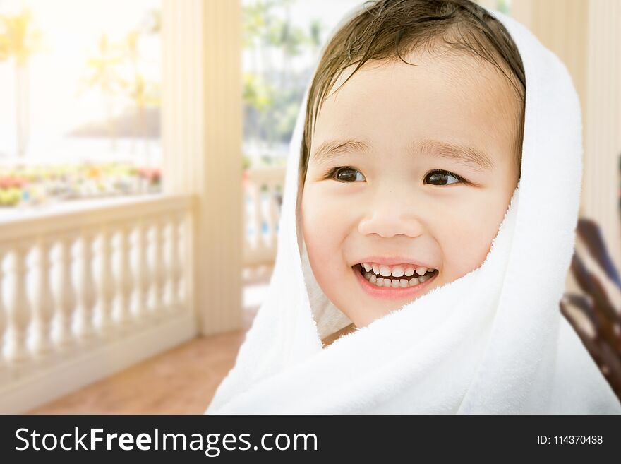 Happy Cute Mixed Race Chinese and Caucasian Boy On Tropical Patio Wrapped In A Towel. Happy Cute Mixed Race Chinese and Caucasian Boy On Tropical Patio Wrapped In A Towel.
