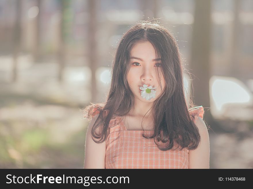 Photo of Woman with Flower on her Mouth