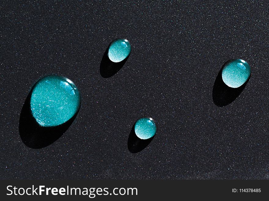 Four Water Droplets on Black Surface