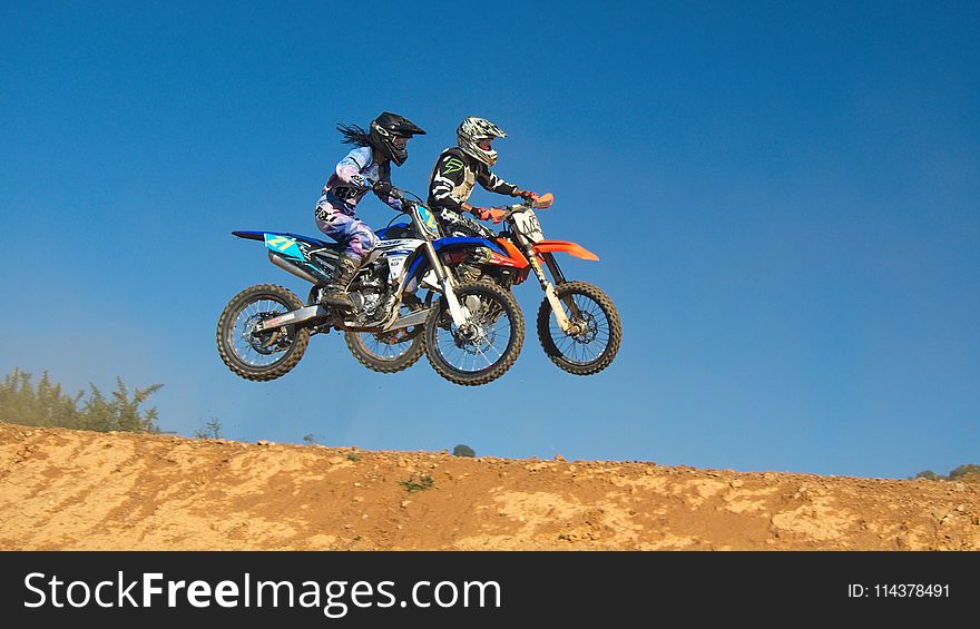 Two Person Riding Motocross Dirt Bikes
