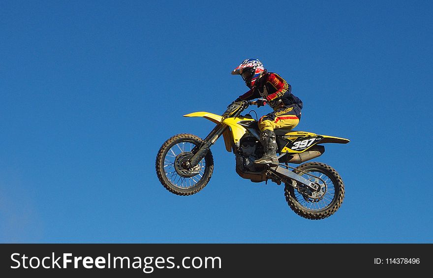 Man Riding Yellow Motocross Dirt Bike