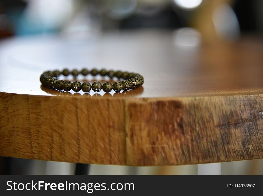 Beaded Gray Bracelet on Brown Wooden Table