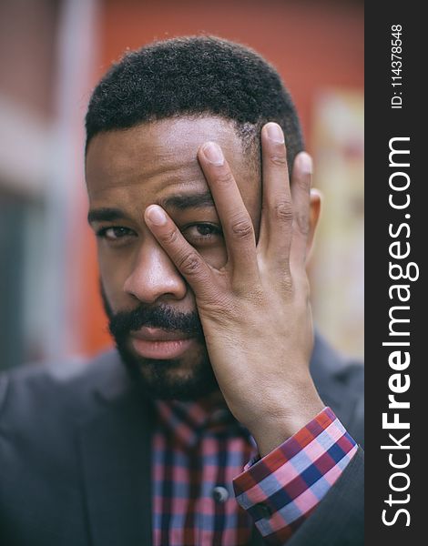 Selective Focus Photography of Man Holding His Face