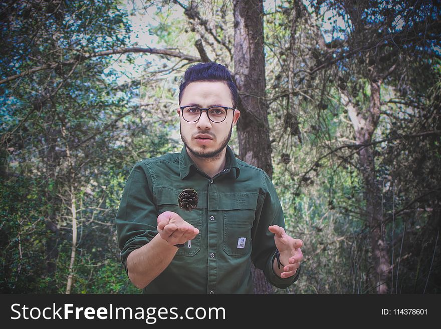 Man Wearing Green Dress Shirt and Surrounded by Trees