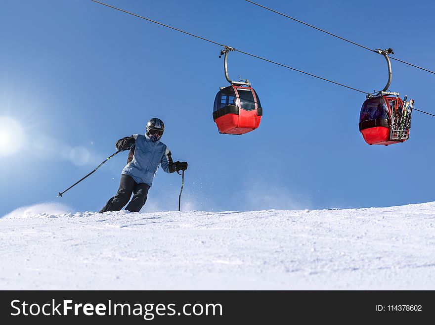 Person Riding Ski On Snow Field