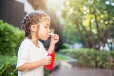Asian Kid Focus On Playing Bubble On Park. Stock Photos