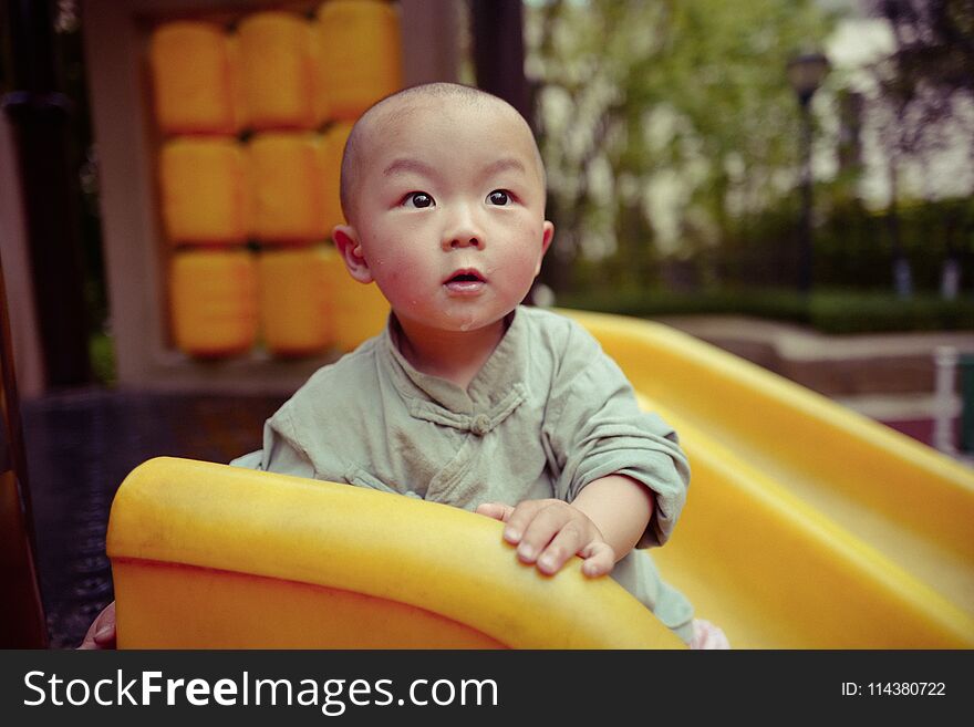 Happy little baby boy on the playground