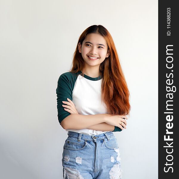 Pretty asian femele smiling joyfully with colorful hair in dress