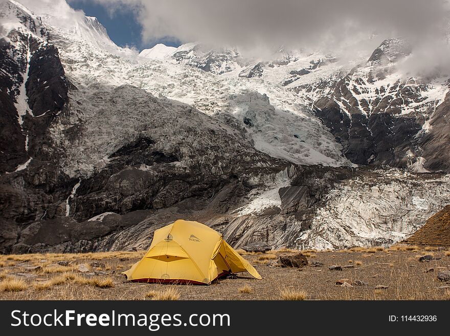 Camping near North Annapurna Base Camp overlooking Annapurna glacier. Outdoor camping scenery with snowy range in Himalayas. Camping outdoor on dramatic mountains background. Version 2. Camping near North Annapurna Base Camp overlooking Annapurna glacier. Outdoor camping scenery with snowy range in Himalayas. Camping outdoor on dramatic mountains background. Version 2.