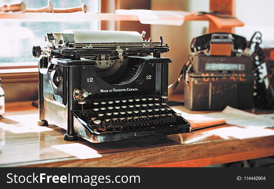 Classic Black Typewriter on Brown Wooden Desk