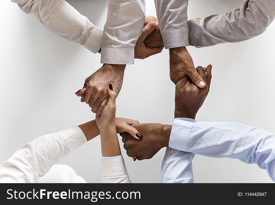 Photo of Four Persons Uniting Hands