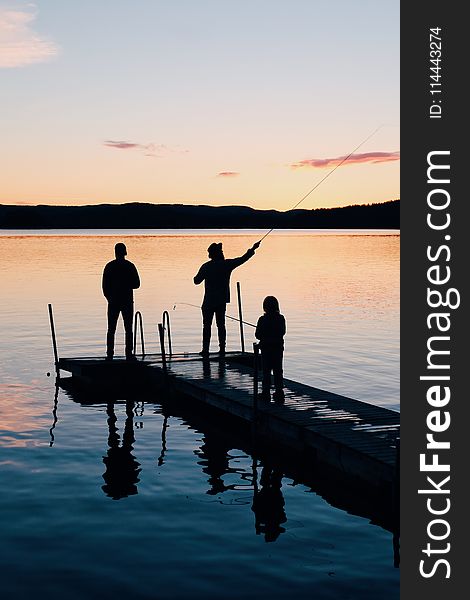 Three People on a Wooden Fishing Docks