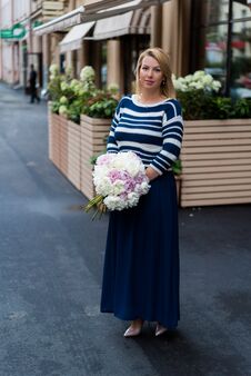 Young Blonde Woman In Blue Dress With Peonies Bouquet Royalty Free Stock Image
