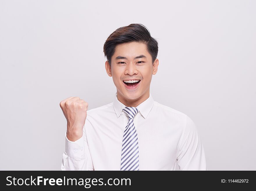 Portrait of happy excited young asian businessman.