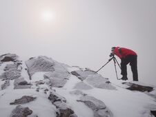 Tall Hiker In Black On Peak Of The World . Heavy Orange Mist Bellow In Valley. Royalty Free Stock Images Tall Hiker In Black On Peak Of The World . Heavy Orange Mist Bellow In Valley. Royalty Free Stock Images