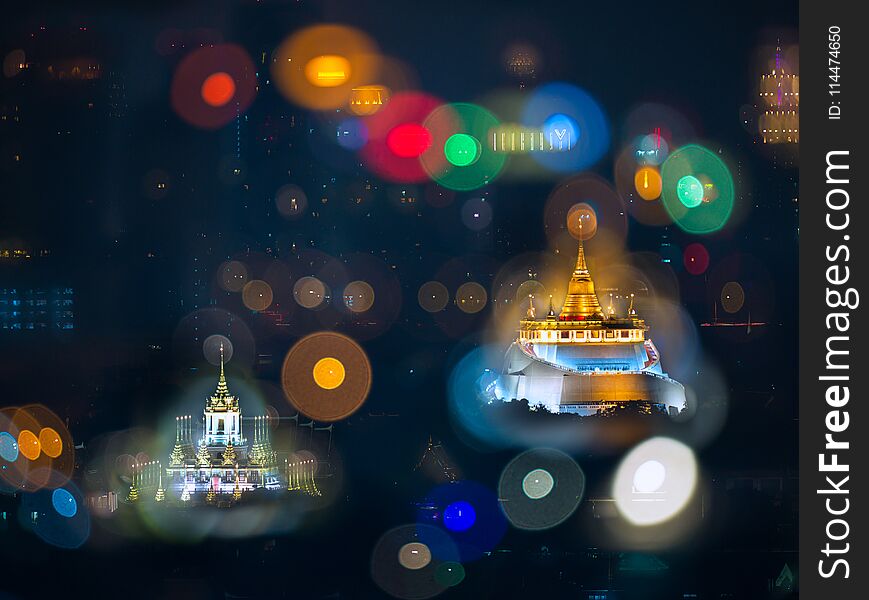 Defocus high view of the light from high building with Goldned mountain and Loha Prasat, Wat Ratchanadda,Bangkok, Thailand