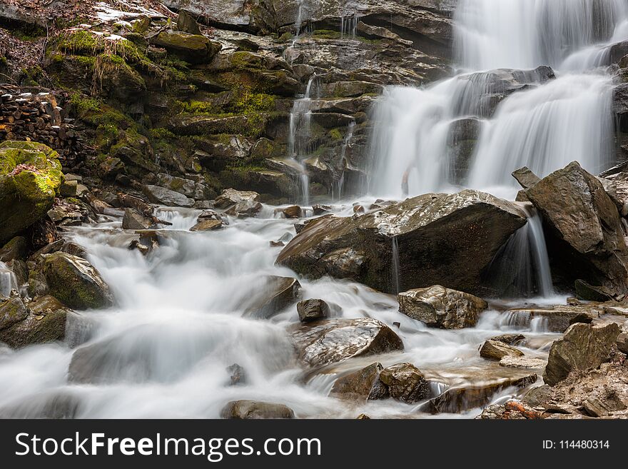 Mountain waterfall with rocky stones, nature background suitable for wallpaper