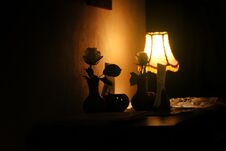 Evening Lamp With Roses And Warm Light In Vintage Room Of Cafe Royalty Free Stock Image