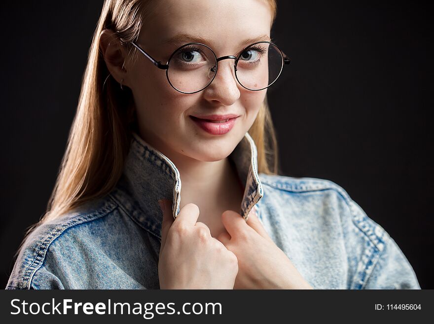 Close Up Portrait Of Beautiful Young Woman Wearing Glasses On Black Background.