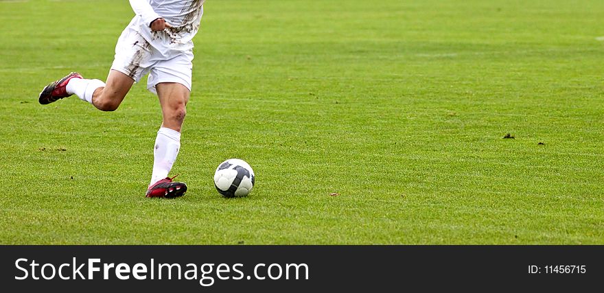 Soccer player running after the ball