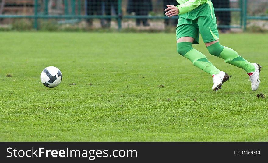 Soccer player running after the ball