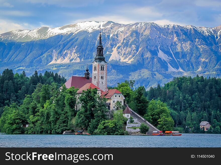 Lake bled with Bled Island and Bled Castle with the blue snow capped Julian Alps in the background. Lake bled with Bled Island and Bled Castle with the blue snow capped Julian Alps in the background.