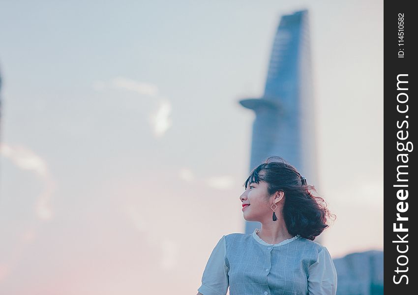 Photo of Woman Wearing Gray Button-up Top