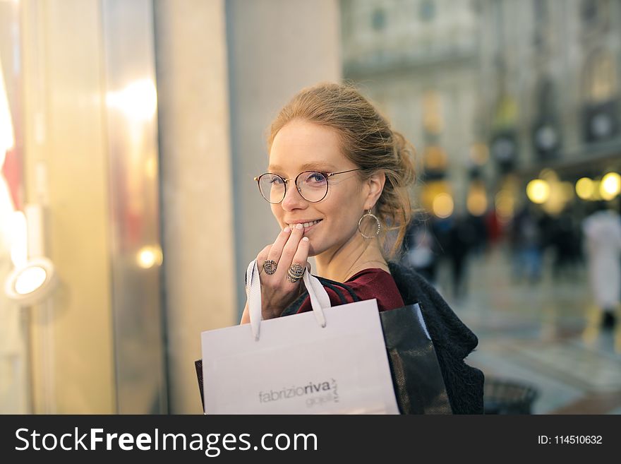 Close-Up Photography of a Woman Holding Paper Bags
