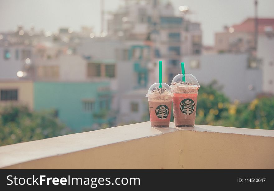 Close-Up Photography of Two Starbucks Disposable Cups