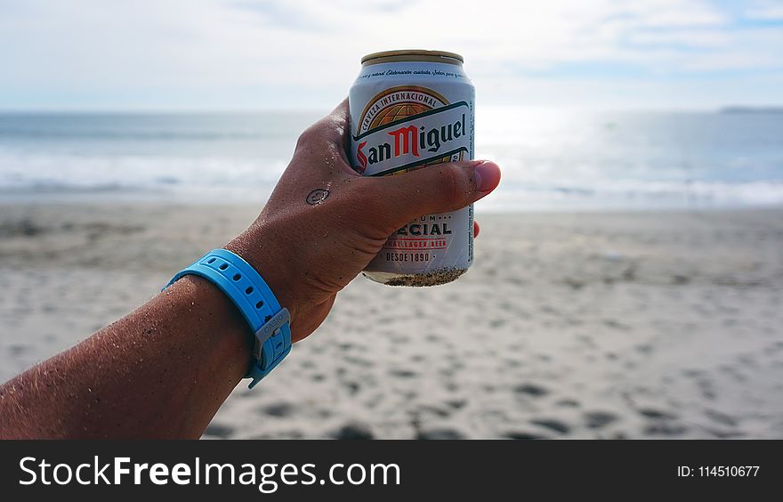 Person Holding San Miguel Beer Tin Can